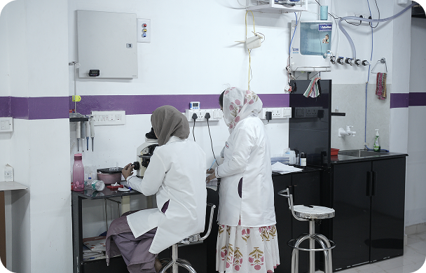 Lab technician with microscope